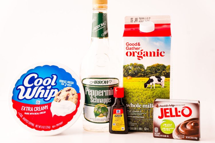 Close up photo of ingredients to make peppermint chocolate pudding shots on a white table.