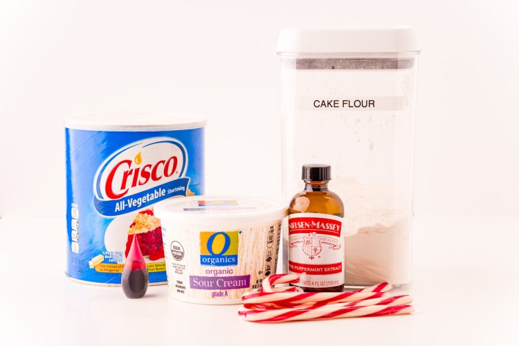 Key ingredients to make peppermint sugar cookies on a white table.