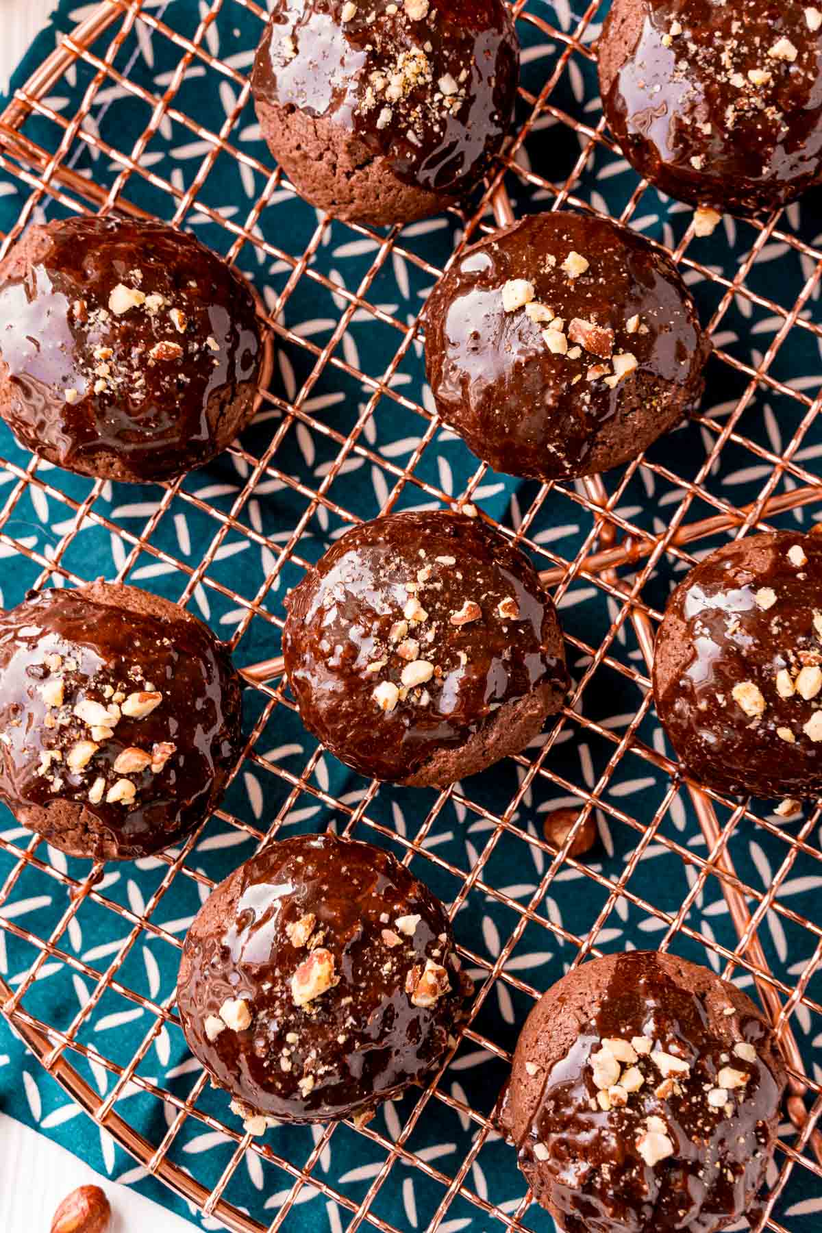 Overhead photo of texas sheet cake cookies on a copper wire rack on a blue napkin.
