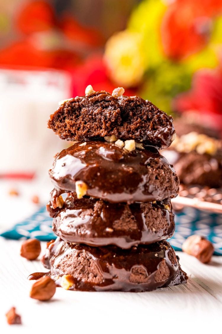 Stack of Texas sheet cake cookies on a white table with the top one missing a bite.