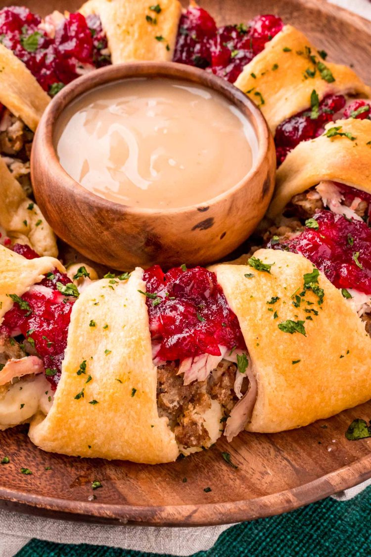 Close up photo of a crescent ring made with Thanksgiving leftovers on a woodern serving board.