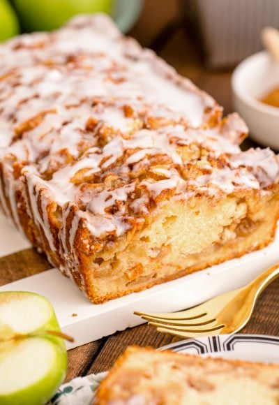 Close up photo of Apple Fritter Bread on a wood and marble cutting board.