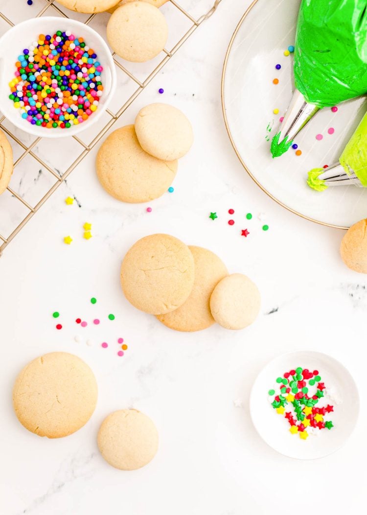 Sugar Cookies ready to be decorated with green frosting to look like christmas trees.