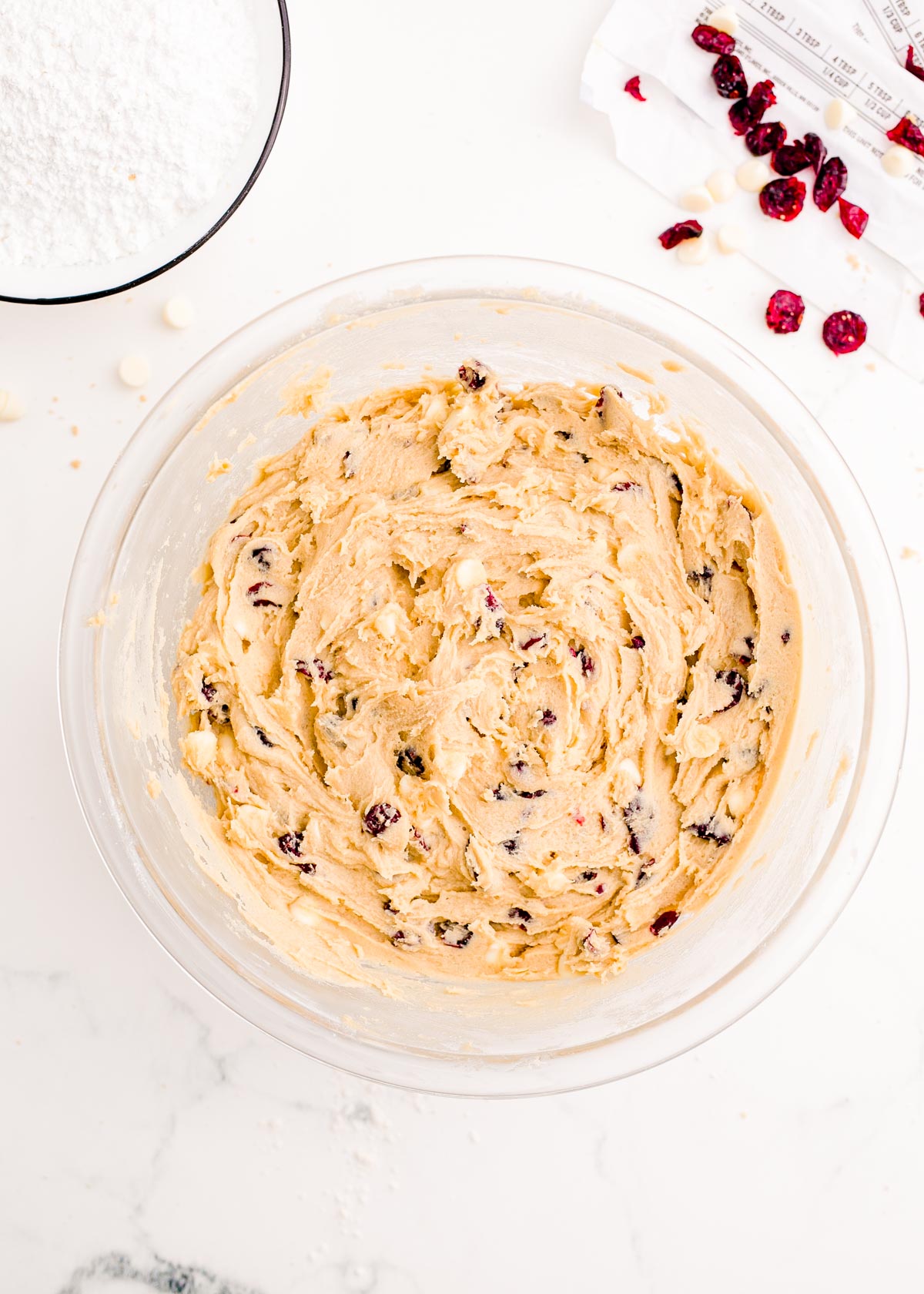 Batter for cranberry bliss bars in a large glass mixing bowl.