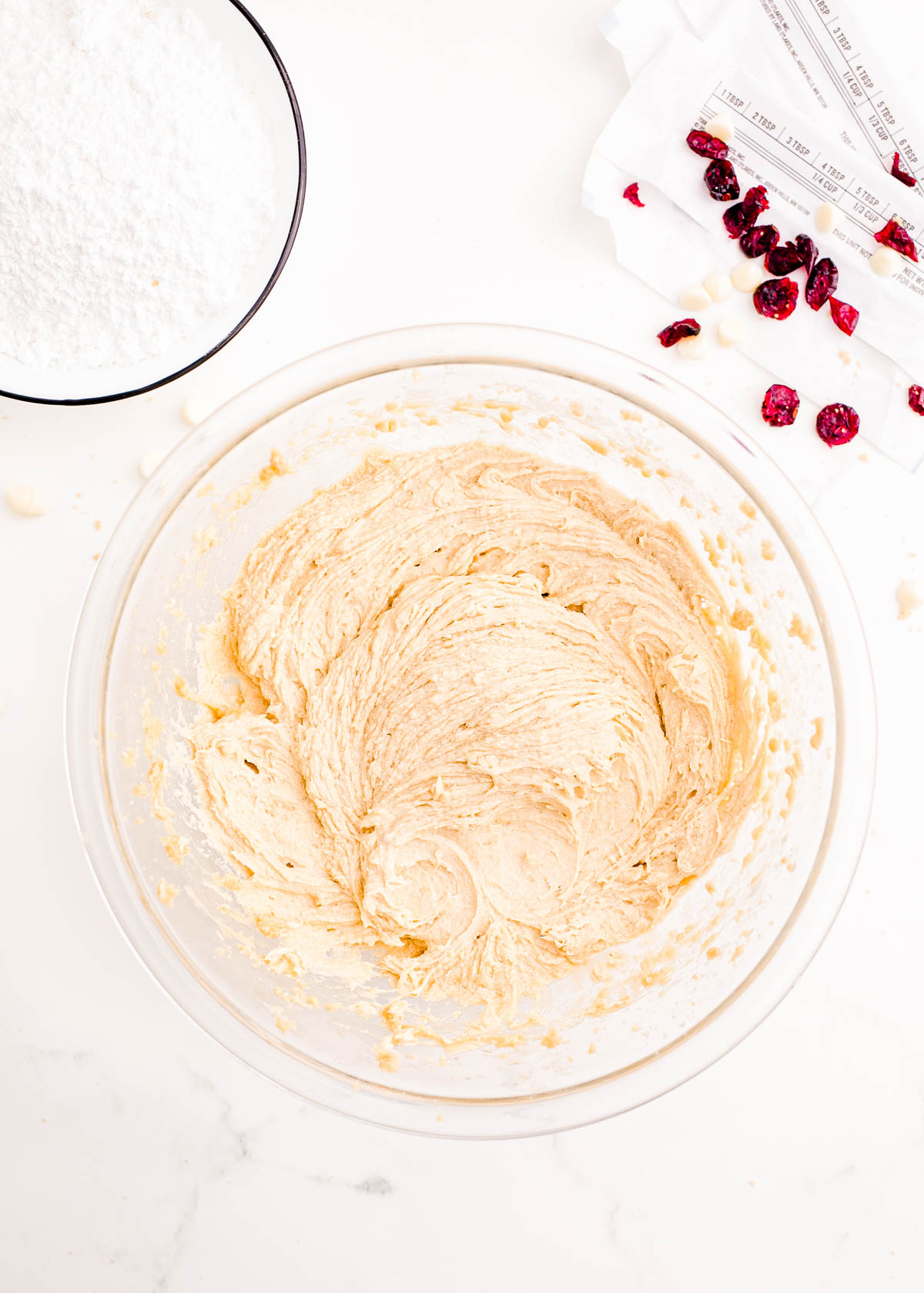 Overhead photo of a glass mixing bowl with the start of blondie batter in it.