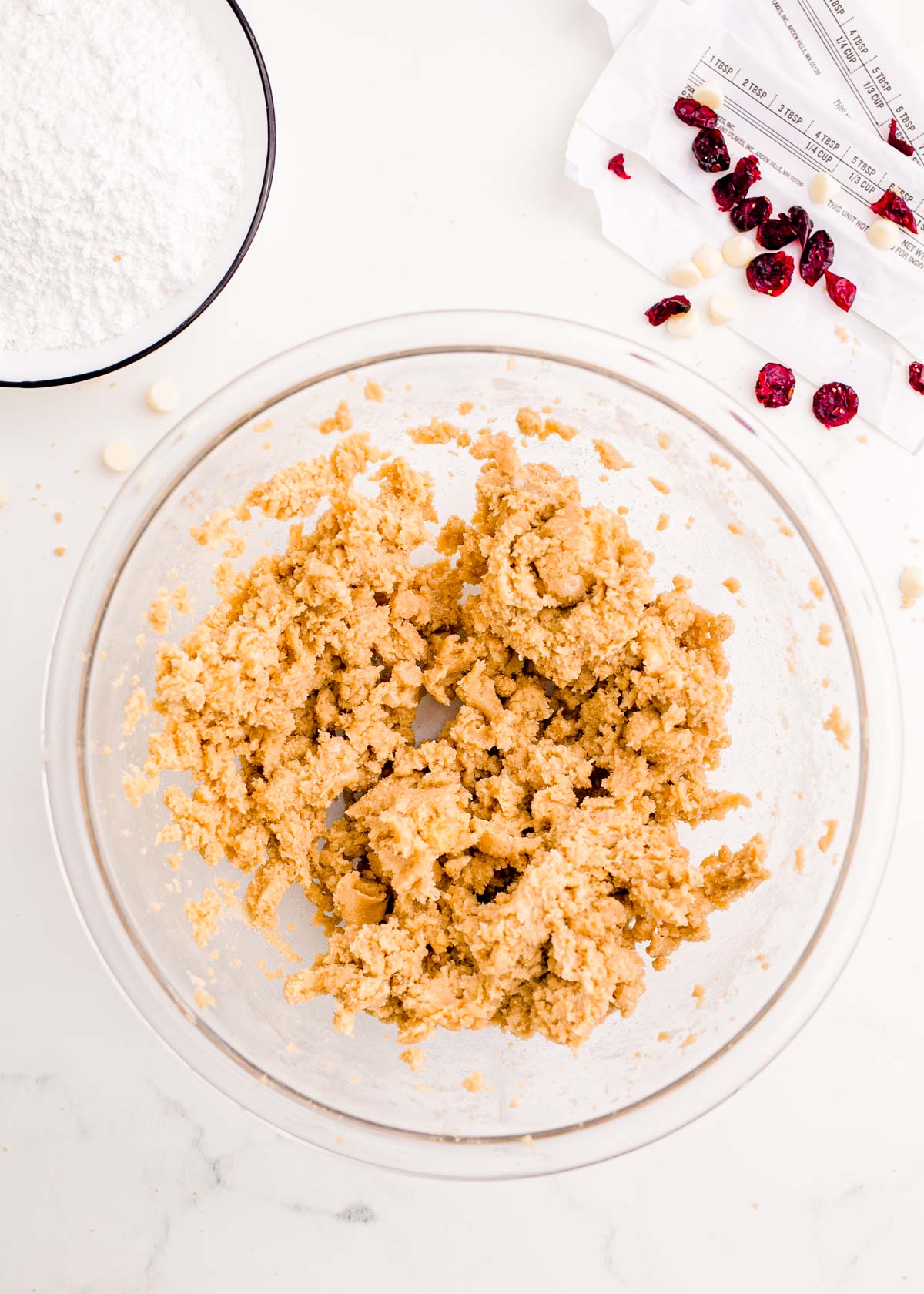 Butter and brown sugar creamed together in a large glass mixing bowl.