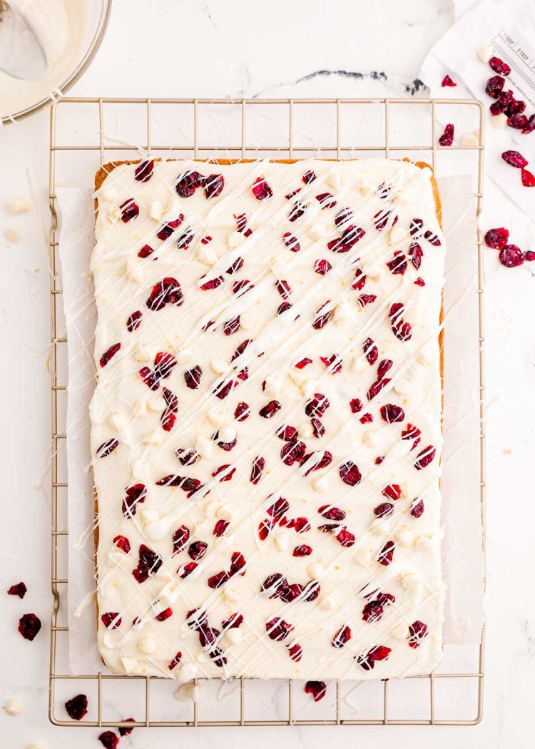 Cranberry bliss bars uncut on a wire rack.