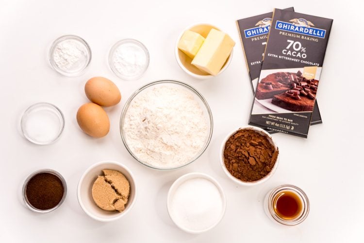 Ingredients to make dark chocolate sugar cookies on a white table.