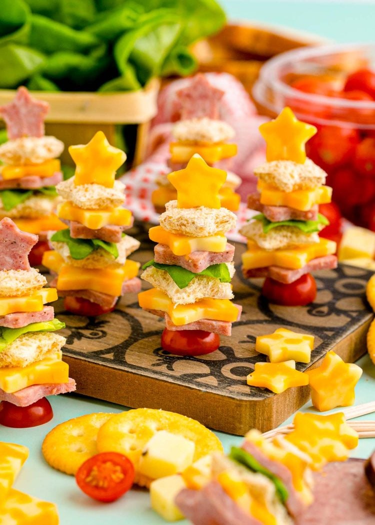 Easy Christmas tree shaped appetizers on a wooden cutting board ready to be served. 