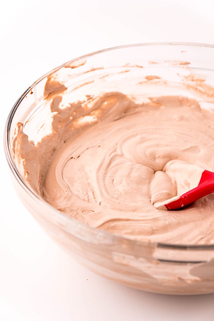 Hot chocolate dip being made in a glass mixing bowl.