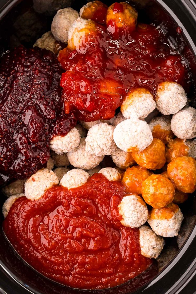 Overhead photo of frozen meatballs and sauces ready to be cooked in a crockpot.