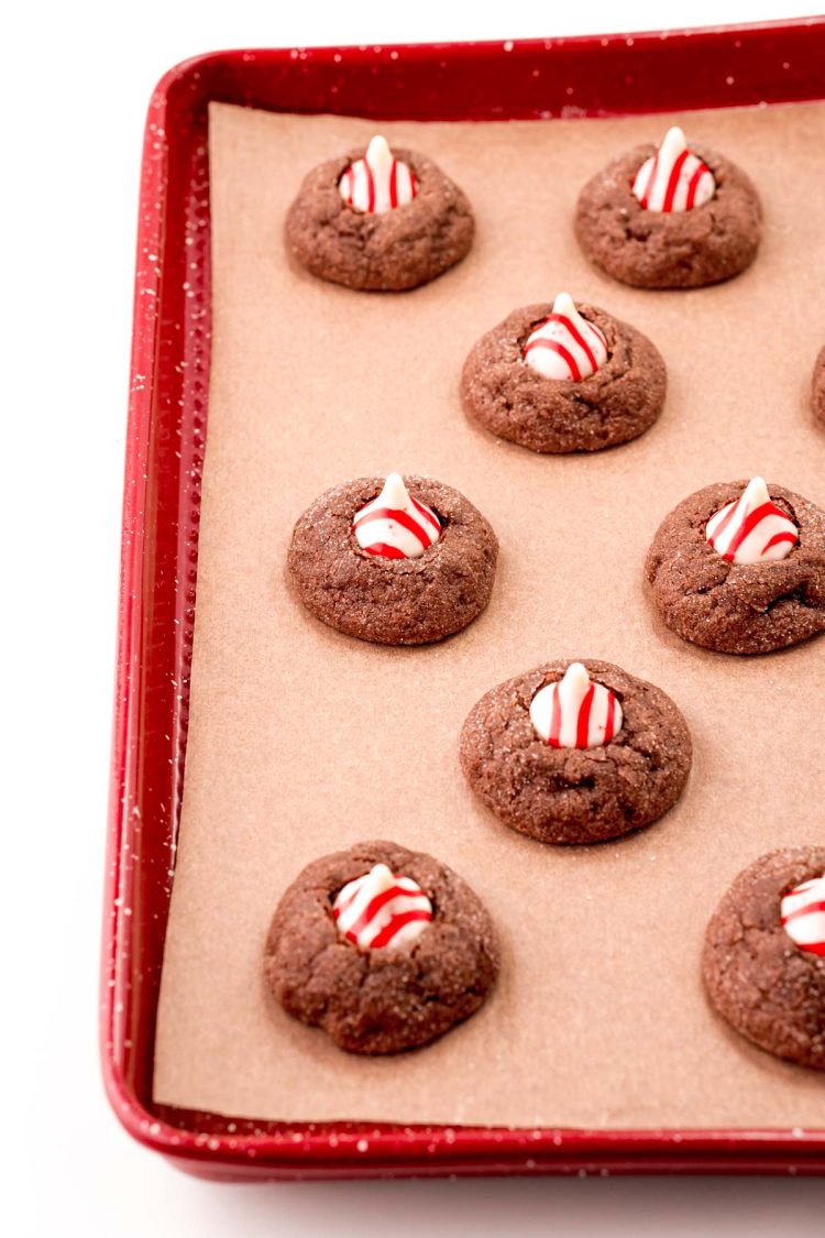 Chocolate thumbprint cookies with peppermint kisses on top.