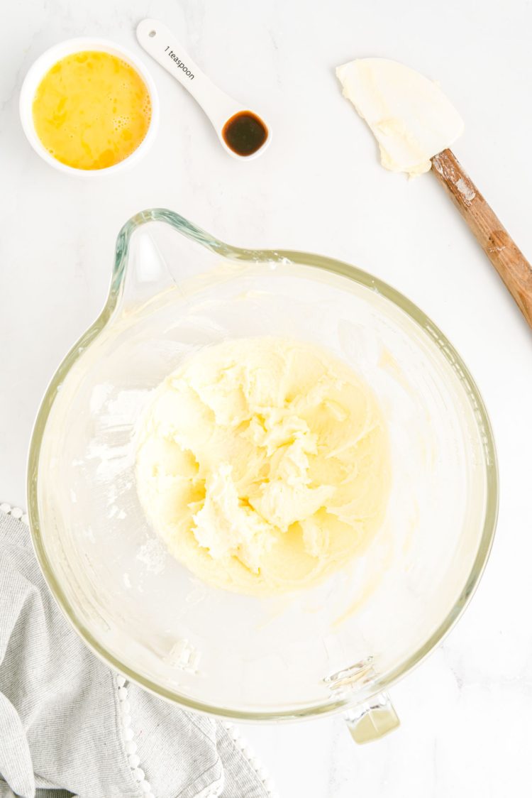 Overhead photo of butter and sugar creamed together in a glass mixing bowl.