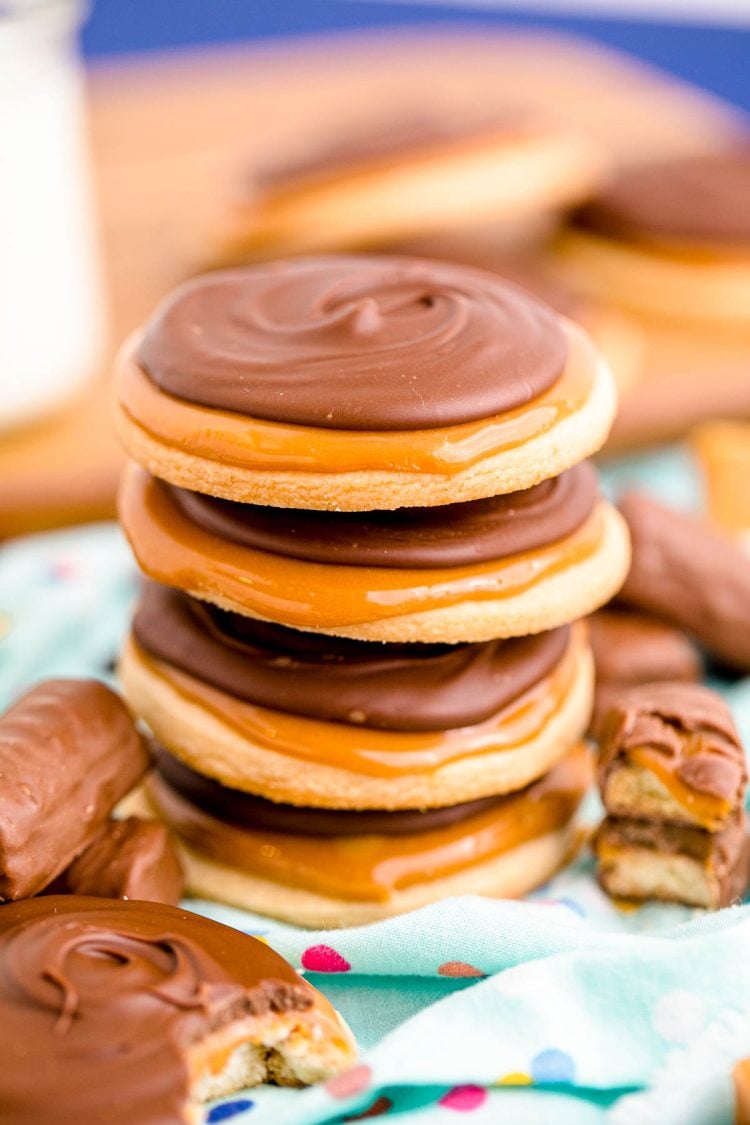 Close up photo of a stack of 4 twix cookies on a light blue napkin.