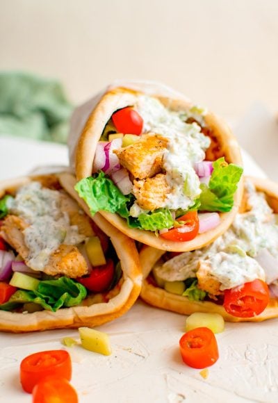 Close up photo of three chicken gyros.