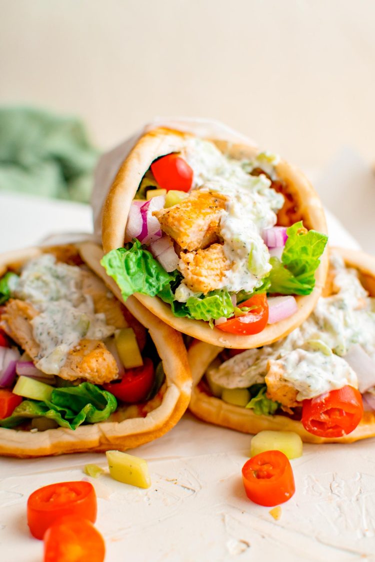 Close up photo of three chicken gyros.