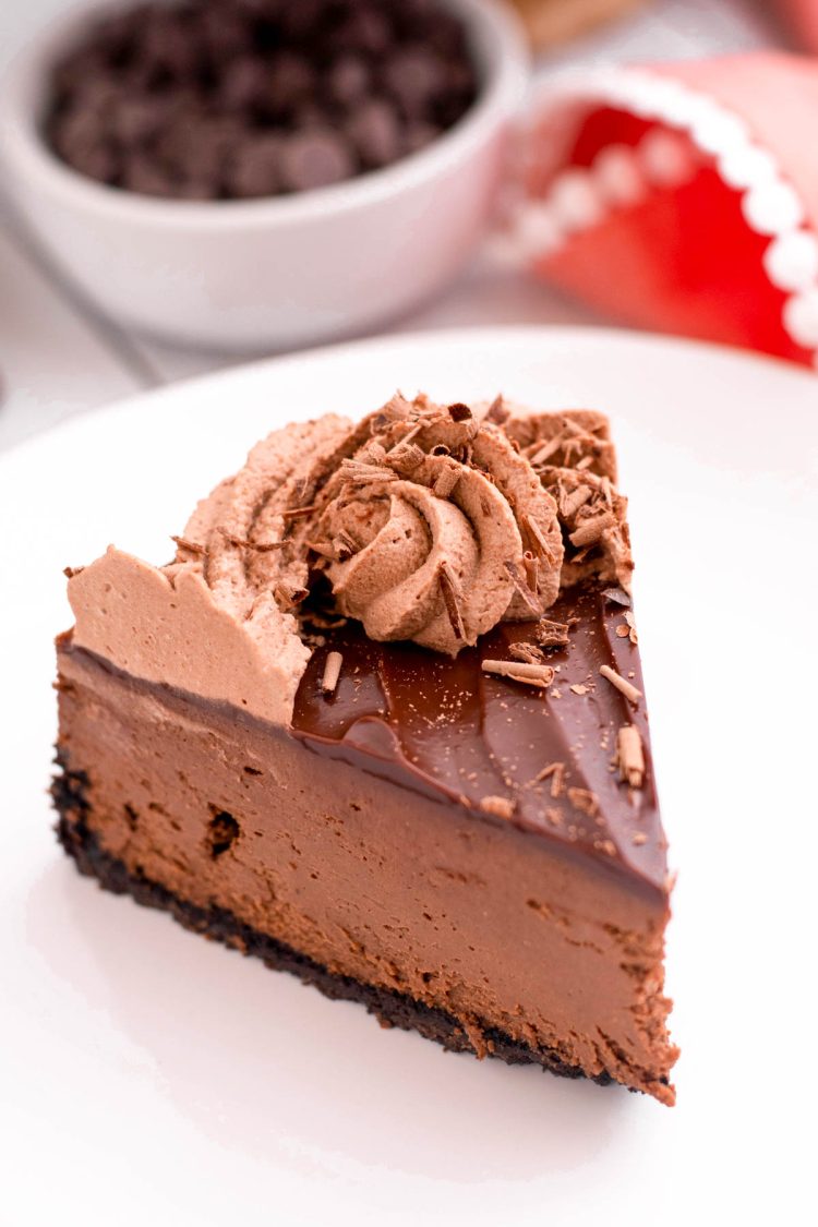 A slice of chocolate instant pot cheesecake on a white plate.