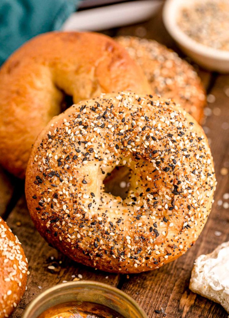 Close up photo of homemade everything bagels on a wooden table.