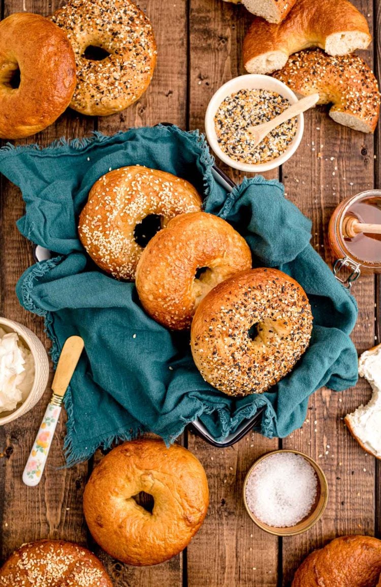 Overhead photo of bagels on a wooden table.