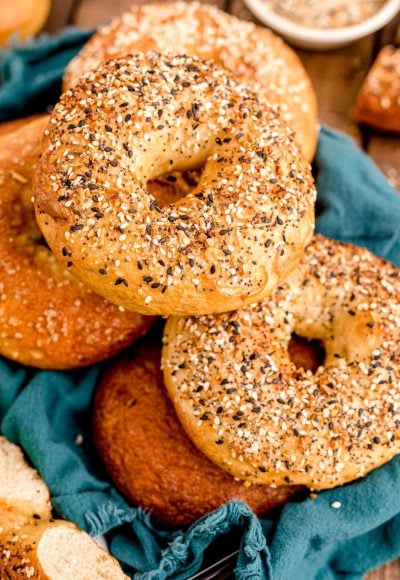 Close up photo of homemade everything bagels on a wooden table.