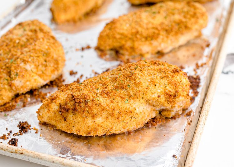 Shake and bake chicken made from scratch on an aluminum lined baking sheet.