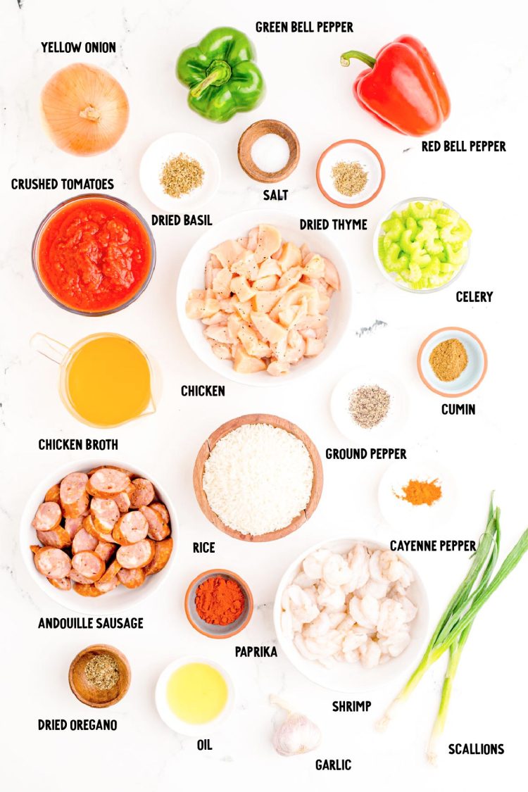 Ingredients to make jambalaya prepped on a marble countertop.