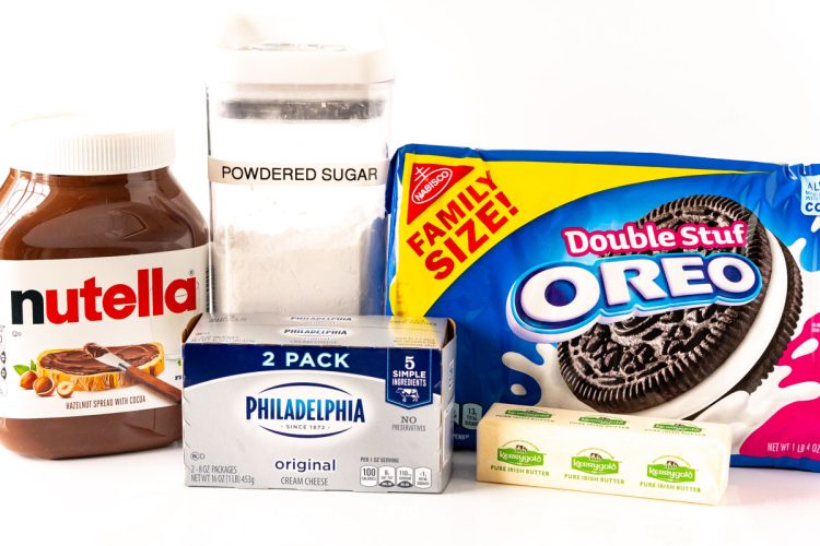 Ingredients to make nutella cheesecake bars on a white surface.