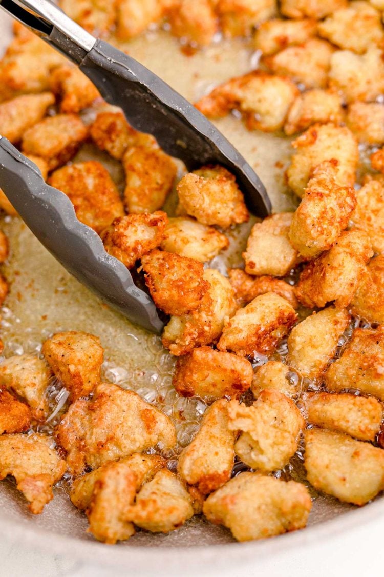 Chicken being cooked in a skillet.