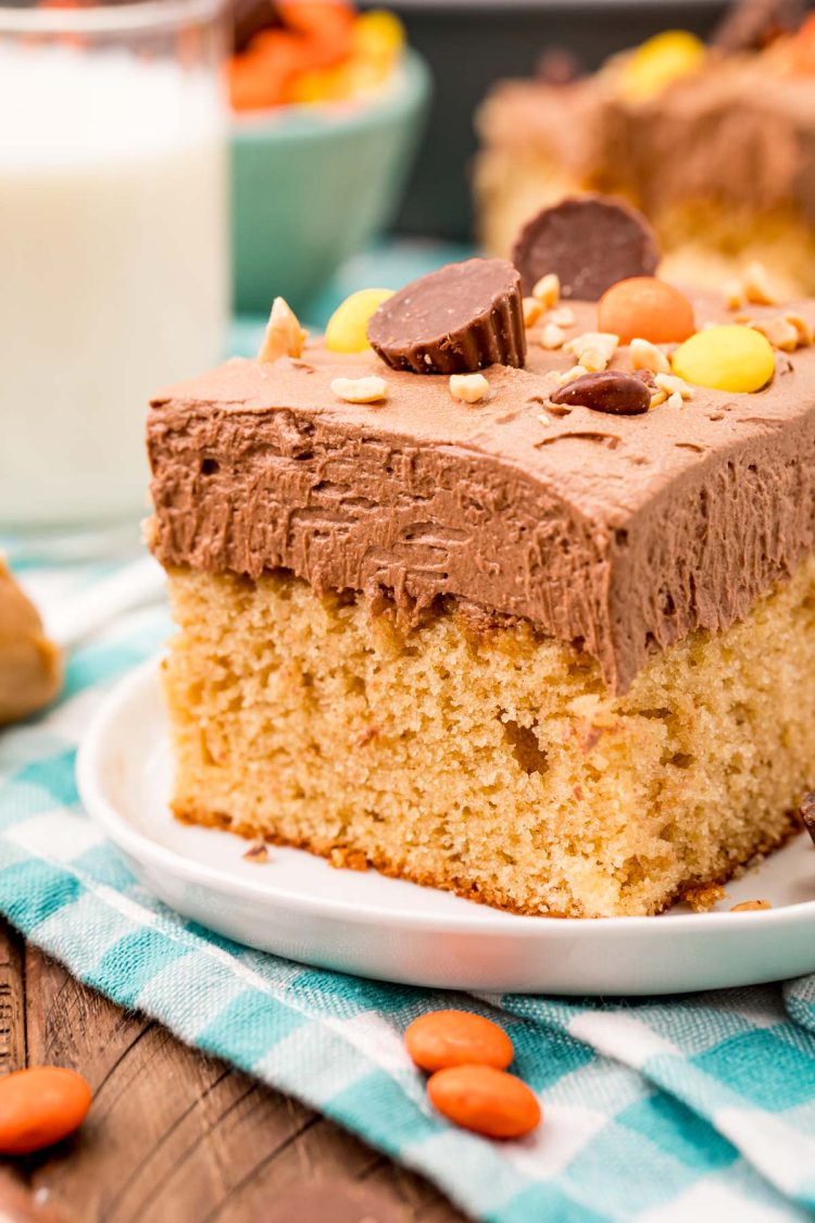 Slice of peanut butter sheet cake on a white plate.