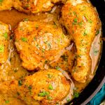 Close up photo of Southern Smothered Chicken in a cast iron pan.