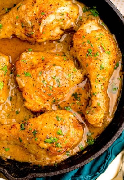 Close up photo of Southern Smothered Chicken in a cast iron pan.