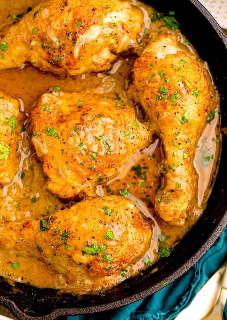 Close up photo of Southern Smothered Chicken in a cast iron pan.