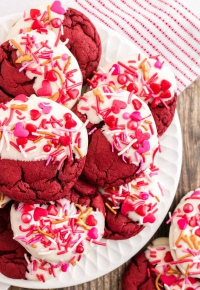 Close up photo of red velvet cookies decorated for Valentine's Day on a white plate.