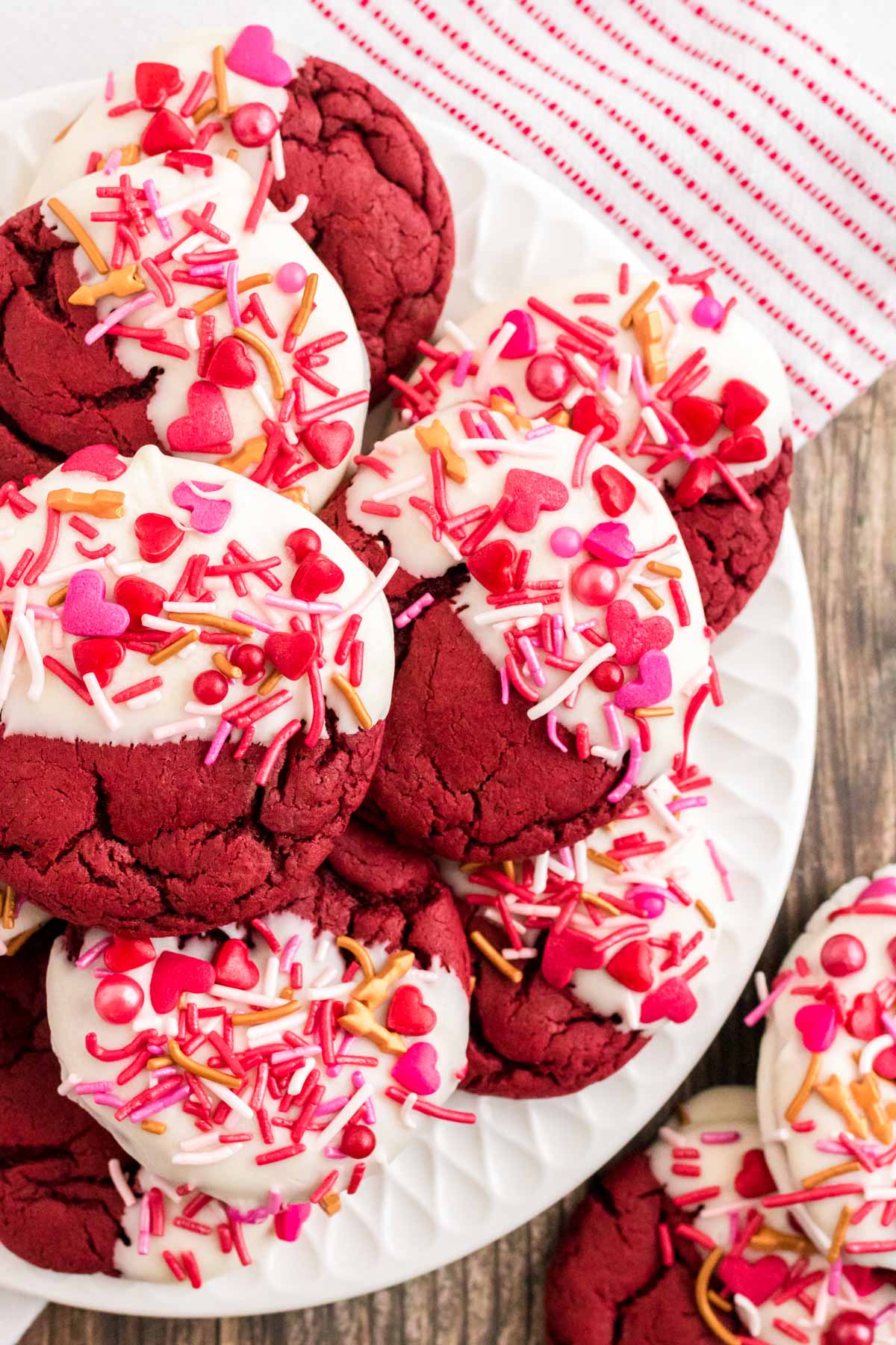 Close up photo of red velvet cookies decorated for Valentine's Day on a white plate.