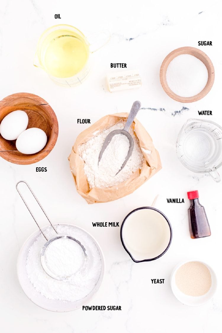 Ingredients to make beignets on a marble counter.