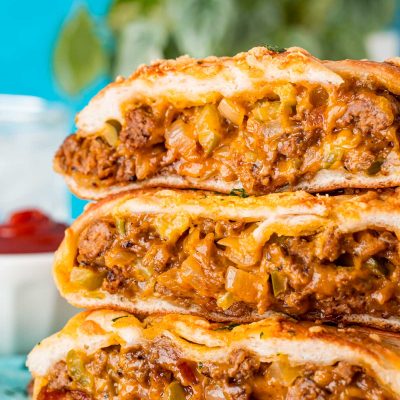 Slices of garbage bread stacked on top of each other on a wooden board.