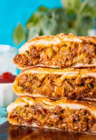 Slices of garbage bread stacked on top of each other on a wooden board.