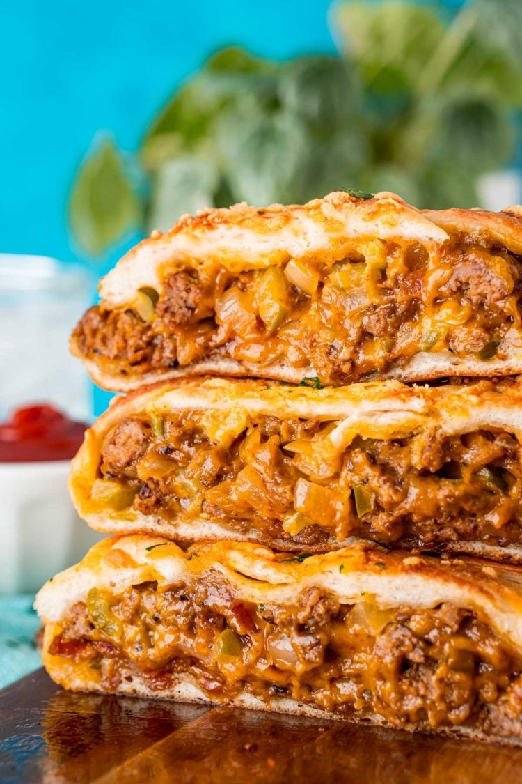 Slices of garbage bread stacked on top of each other on a wooden board.