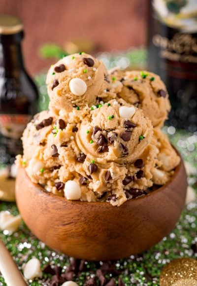 Close up photo of a wooden bowl filled with Irish Cream flavored edible cookie dough on a green placemat.