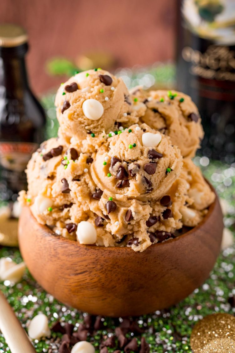 Close up photo of a wooden bowl filled with Irish Cream flavored edible cookie dough on a green placemat.