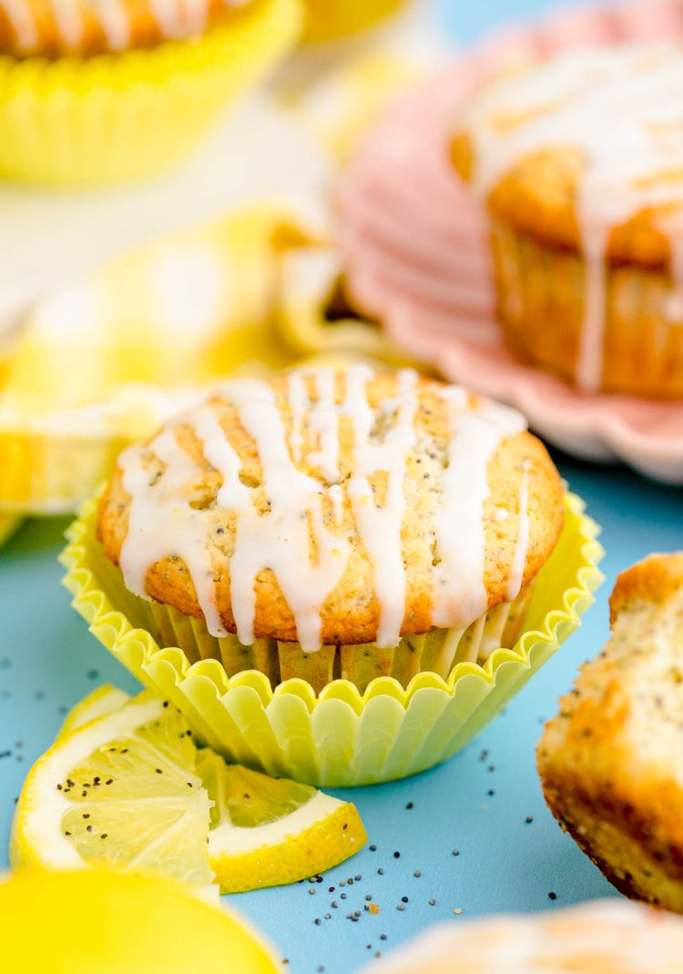 Lemon poppyseed muffins on a blue table.