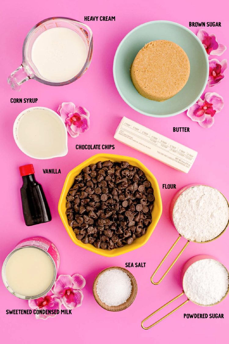 Ingredients to make millionaire bars prepped on a pink surface.