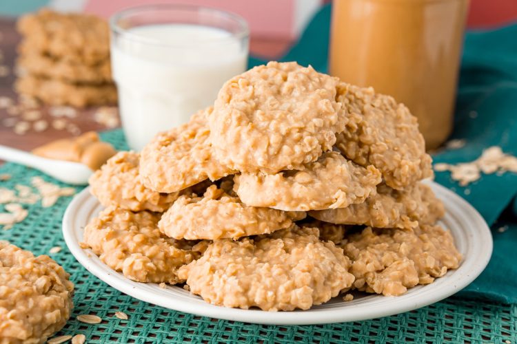A white plate filled with peanut butter no bake cookies on a teal placemat.