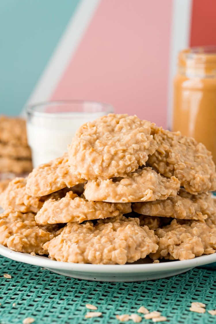 A white plate filled with peanut butter no bake cookies on a teal placemat.