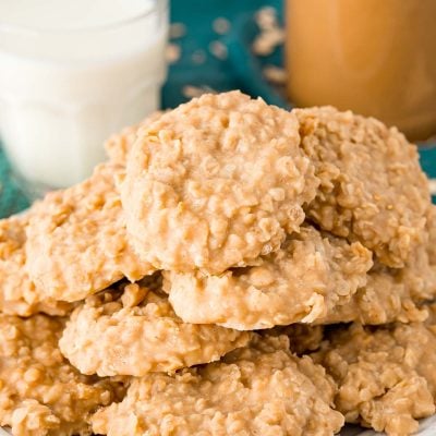 Peanut butter no bake cookies on a white plate on a teal placemat.