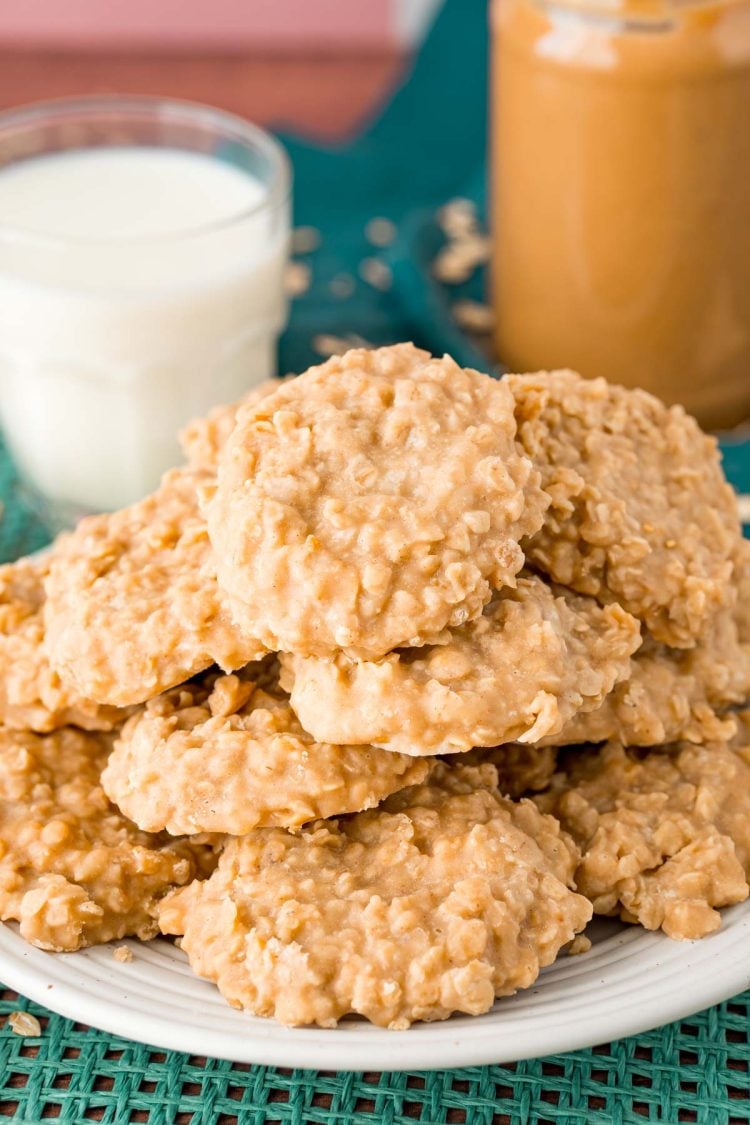 A white plate filled with peanut butter no bake cookies on a teal placemat.