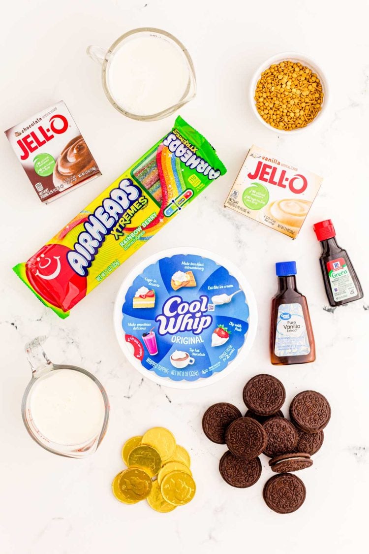 Ingredients to make St Patrick's Day Pudding Cups on a marble surface.