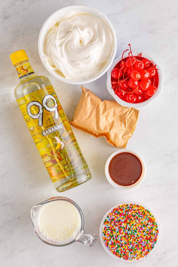 Ingredients to make banana split pudding shots on a gray surface.