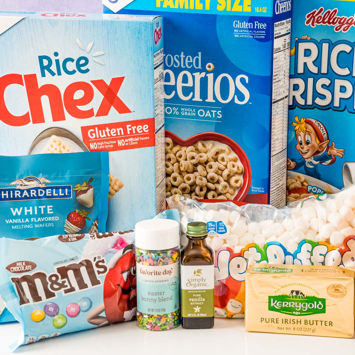 Ingredients to make easter rice krispie treats on a white table.