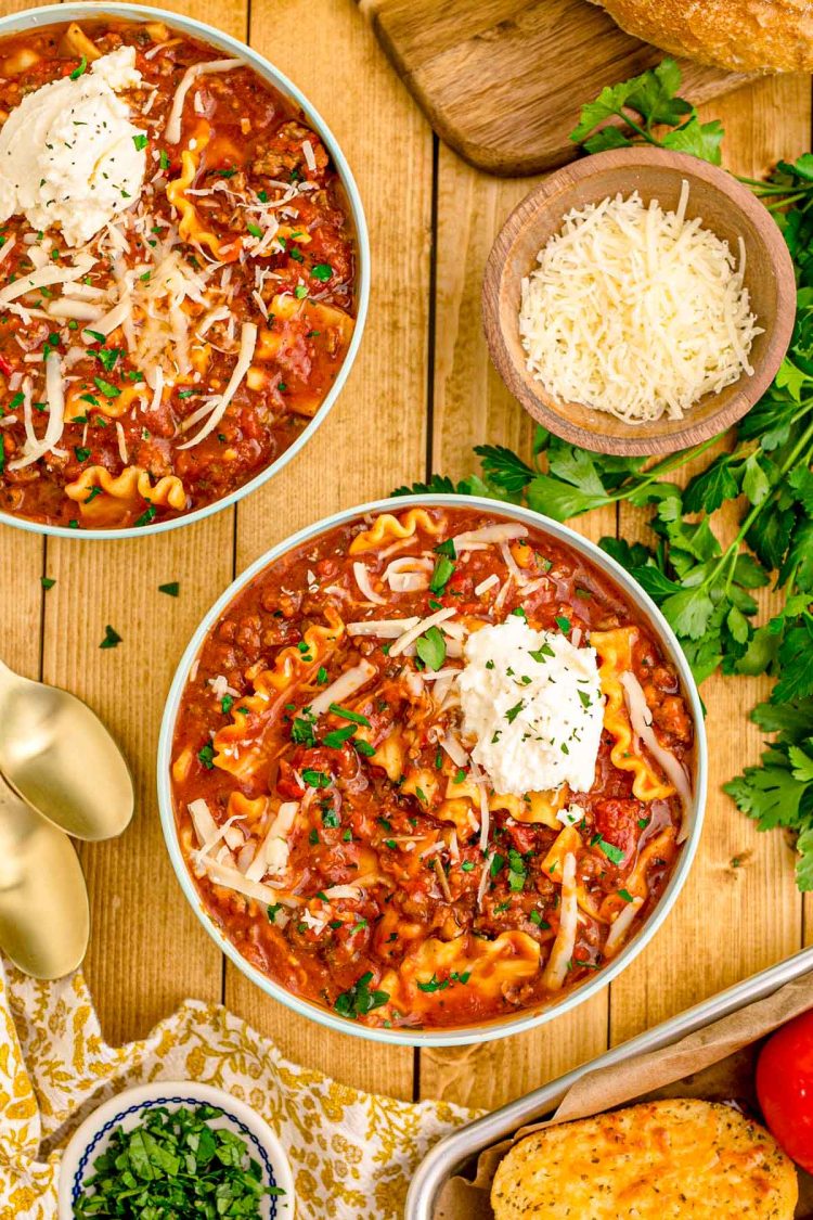 Overhead photos of bowls of lasagna soup on a wooden table.